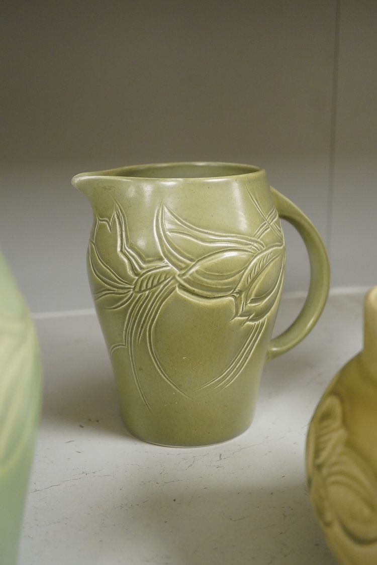 Three Susie Cooper green floral incised jugs, signed to the bases, tallest 16cm high